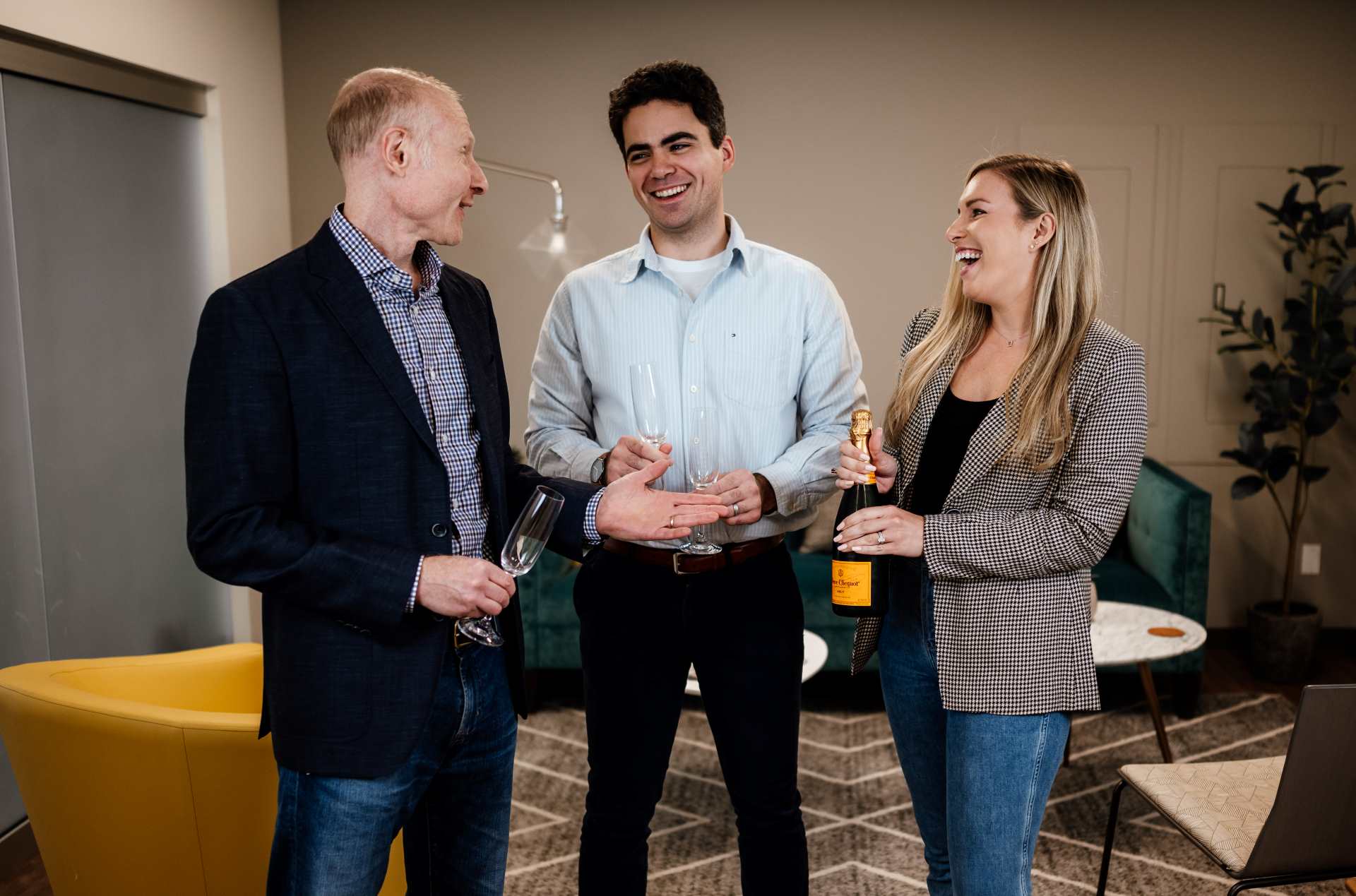 Three founders of a digital marketing agency celebrating over champagne