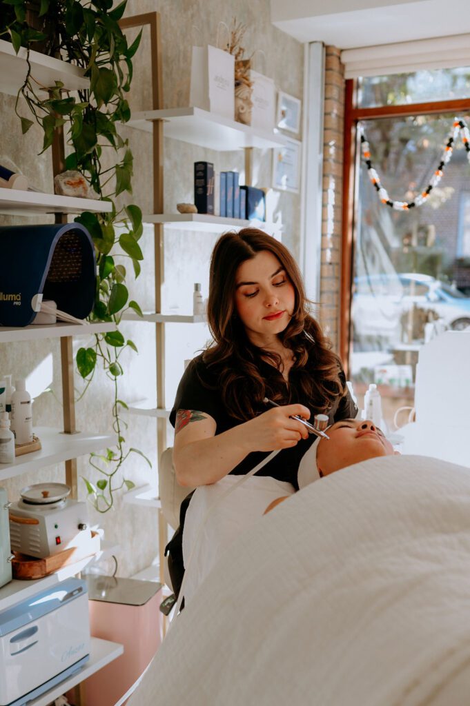 Esthetician hands applying skincare treatment