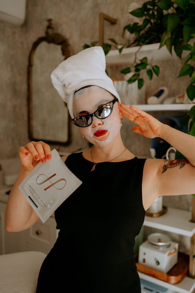 Close-up branding image of esthetician applying skincare mask